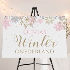 a sign that says oliva's winter onederland with snowflakes on it