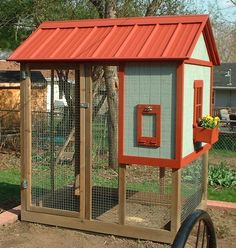 a small chicken coop with a red roof