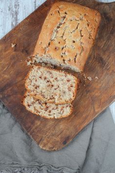 a loaf of bread sitting on top of a wooden cutting board