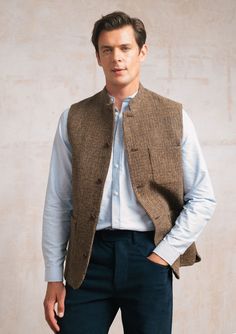 Welcome our newest addition - the Brown Harris Tweed Waistcoat. Handwoven in the Outer Hebrides of Scotland from pure virgin wool, Harris Tweed is the fabric of choice wherever quality and provenance are valued. A classic single-breasted design with our signature Nehru collar offers a contemporary silhouette. It features a smooth viscose lining for easy layering, sustainably sourced Corozo nut buttons and roomy patch pockets. Dress up with a grandad shirt or down with a crew neck jumper. Mens Waistcoat Fashion, Mens Wool Vest, Tweed Waistcoat, Mens Waistcoat, Waistcoat Men, Wool Vest, Crew Neck Jumper