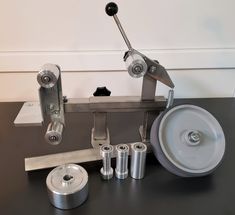 an image of a machine that is on the table with tools in front of it