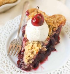 a slice of cherry pie with ice cream on top