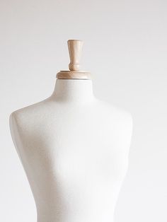 a white mannequin with a wooden top