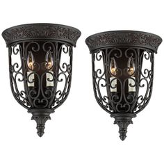 two light wall sconces with ornate iron designs