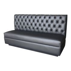 a black leather couch sitting on top of a white floor