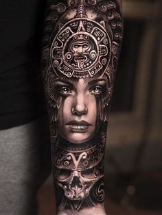 a woman's arm with tattoos on it and an intricate design in the middle