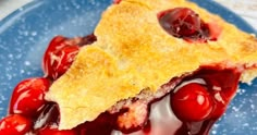 a piece of cherry pie on a blue plate