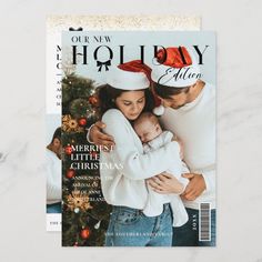 a magazine cover with a photo of two people holding a baby in front of a christmas tree