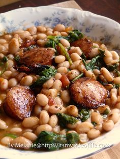 a white bowl filled with beans and spinach