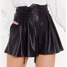 These Shorts Come In Faux Leather And Feature A High-Waisted, Relaxed Silhouette, Zip Closure, Pleat Detailing, And Slim Tie. High Waist Shorts For Fall Date Night, Chic Faux Leather Shorts With Belt Loops, Going Out Leather Short Bottoms, Leather Going Out Shorts, Chic Leather Party Shorts, Elegant Faux Leather Bottoms For Day Out, Elegant Faux Leather Shorts, Faux Leather Short Bottoms For Day Out, Chic Faux Leather Short Bottoms