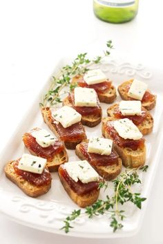 small pieces of bread with cheese and meat on them