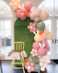 the balloon arch is decorated with pastel colors