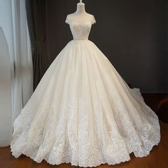 a white wedding dress on display in front of a window