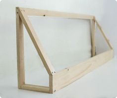 a wooden frame is shown with the bottom cut out to show it's reflection