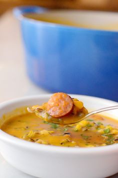 a white bowl filled with soup and a spoon