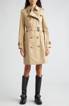 The iconic Burberry Heritage trench coat is expertly cut from water-resistant cotton gabardine with all the classic details, including the check lining. 38" length (size 8) Double-breasted button closure Point collar with throat latch Belted cuffs Front button-welt pockets Epaulets Button gun flap; storm flap Removable belt Back vent Lined 100% cotton with leather buckles Dry clean Made in the UK Designer Clothing Designer Gabardine Outerwear, Classic Gabardine Outerwear With Double-breasted Fastening, Classic Double-breasted Gabardine Outerwear, Leather Buckle, Welt Pockets, Elegant Fashion, Clothing Items, Double Breasted, Burberry