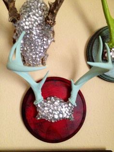 two deer antlers with silver sequins on them