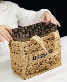 a person is holding a crocheted bag with chocolate in it and the words christian shop on it