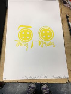 a piece of paper with the words happy birthday written on it and two yellow balloons