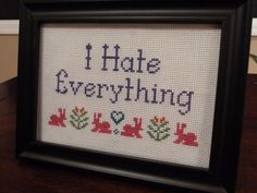 a cross - stitch sign that says i hate everything