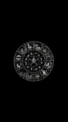 a black and white photo with zodiac signs in the center, on a dark background