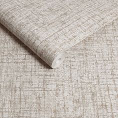 an upholstered fabric in beige and white with small squares on the back side