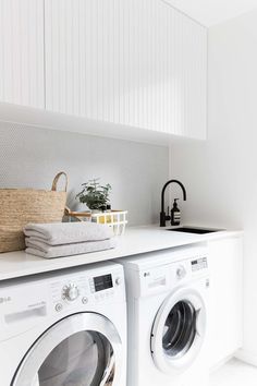 a washer and dryer sitting on top of a white counter in a laundry room