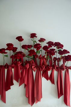 red wedding trend. red roses on display with red silk ribbon bows.