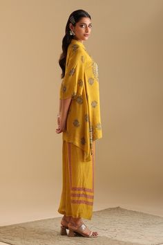 Yellow shirt kurta with floral print and sequin, bead embroidery. Paired with stripe print flared pant. - Aza Fashions Yellow Palazzo Set With Printed Motifs In Traditional Drape, Traditional Yellow Palazzo Set With Printed Motifs, Yellow Palazzo Set With Printed Motifs And Traditional Drape, Traditional Festive Pant Set With Set-in Sleeves, Yellow Cotton Silk Sets With Printed Motifs, Yellow Printed Cotton Silk Sets, Designer Sets With Set-in Sleeves And Traditional Drape, Festive Yellow Blouse With Printed Motifs, Traditional Silk Sets With Set-in Sleeves