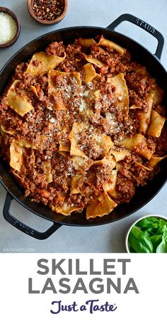 skillet lasagna in a cast iron skillet with text overlay that reads skillet lasagna just a taste