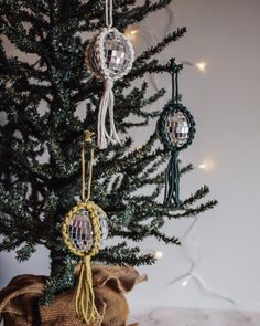 a small christmas tree with ornaments hanging from it