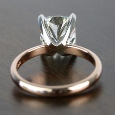 a close up of a diamond ring on a table