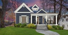 a blue house with white trim on the front porch and steps leading up to it