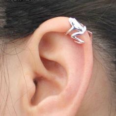 a close up of a person's ear with a small silver object on it