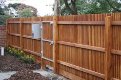 a wooden fence with an electrical box attached to it