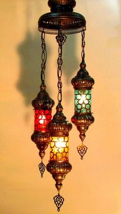 three colorful lights hanging from a ceiling fixture