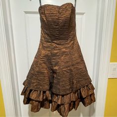 New With Tags No Rips, Tears, Or Stains. Size 7/8 (Marked As Juniors On Sales Tag) Iridescent Brown With Hints Of Black Undertone (Like A Copper) Strapless Back Zipper Inner Lining With Tulle Corset Top With Inner Boning Crinkled Dress 3-Poofy Layers At The Bottom Hanger Ribbons Intact *Please Note The Colors In The Photos May Differ Slightly From The Items True Color** Smoke-Free And Pet Friendly Home. Please Refer To Pictures For Approximate Measurements While Item Is Lying Flat. Please Review Brown Knee-length Evening Mini Dress, Brown Knee-length Mini Dress For Evening, Formal Fitted Brown Mini Dress, Formal Brown Fitted Mini Dress, Brown A-line Lined Dress, Brown A-line Cocktail Dress, Brown Mini Length Dress For Formal Occasions, Formal Brown Mini Length Dress, Brown Mini Length Formal Dress