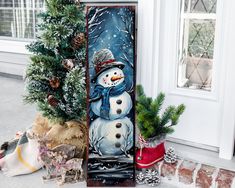 a snowman is standing next to a christmas tree and other decorations on the front porch