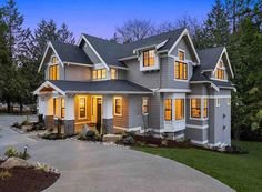 a large gray house with lots of windows on it's front and side sides