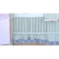 a baby crib with pink and blue bedding