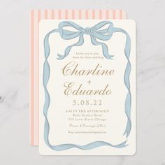 a wedding card with a bow on the front and ribbon at the bottom, in pink and blue