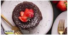 chocolate cake with strawberries and powdered sugar on the top, next to two forks