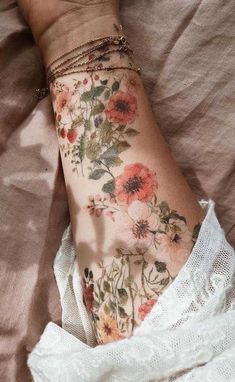 a woman's arm with flowers on it