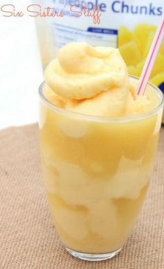 a glass with some food in it and a straw sticking out of the top, sitting on a table