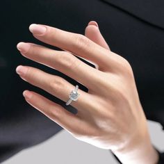 a woman's hand with a diamond ring on it