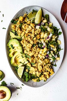 a white plate topped with an avocado salad