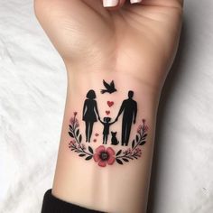 a woman's wrist tattoo with an image of two people and a dog on it