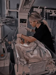 a woman in a hospital bed with an iv machine