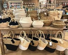 many baskets are lined up on a shelf in a store with other items behind them