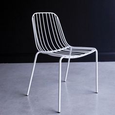 a white chair sitting on top of a cement floor